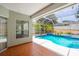 Screened-in pool area, showing the pool and patio with tropical landscaping at 8023 Canyon Lake Cir, Orlando, FL 32835