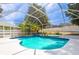 Screened-in pool area with a pool, tropical plants, and views of the backyard at 8023 Canyon Lake Cir, Orlando, FL 32835