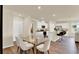 Dining area with a glass table and six chairs, next to a kitchen and living area at 1068 Clay Blvd, Tavares, FL 32778