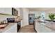 Bright kitchen boasts stainless steel appliances, ample counter space, white cabinetry, and durable wood flooring at 1068 Clay Blvd, Tavares, FL 32778