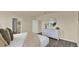 Serene bedroom showcasing a stylish bed, a round mirror on the wall, and abundant natural light at 1068 Clay Blvd, Tavares, FL 32778