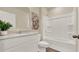 Bright bathroom featuring a white vanity with stone countertop, tub, shower, and modern fixtures at 1076 Clay Blvd, Tavares, FL 32778