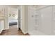 Bathroom featuring a shower, with wood-look flooring, and an open doorway to a bedroom at 1076 Clay Blvd, Tavares, FL 32778