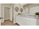 Bathroom featuring a double vanity with stone countertops and modern fixtures, with wood-look flooring at 1076 Clay Blvd, Tavares, FL 32778