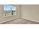 This bedroom has carpet flooring and a window providing natural light at 1076 Clay Blvd, Tavares, FL 32778