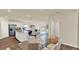Open-concept living space featuring eat-in dining area, hardwood floors, and modern appliances at 1076 Clay Blvd, Tavares, FL 32778