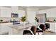 Modern kitchen featuring stainless steel appliances, a large island with seating, and sleek white cabinetry at 1076 Clay Blvd, Tavares, FL 32778