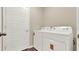 Laundry room with modern washer and dryer units, wood-look flooring and a white door at 1076 Clay Blvd, Tavares, FL 32778