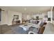 Open-concept living space featuring hardwood floors, modern decor and a view of the kitchen at 1076 Clay Blvd, Tavares, FL 32778