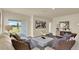 Spacious living room featuring hardwood floors, neutral walls, modern décor, and sliding glass doors at 1076 Clay Blvd, Tavares, FL 32778