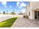 Spacious backyard with covered patio, green lawn, and stone pavers, perfect for outdoor relaxation at 1103 Silo Dr, St Cloud, FL 34771