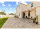 Large backyard with manicured lawn, stone pavers, and covered patio, ideal for outdoor entertaining at 1103 Silo Dr, St Cloud, FL 34771
