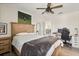 A bedroom boasts a ceiling fan, neutral colors, and wood floors at 1103 Silo Dr, St Cloud, FL 34771