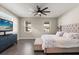 Comfortable bedroom featuring a large ceiling fan, accent wall, and hardwood flooring at 1103 Silo Dr, St Cloud, FL 34771