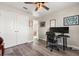 Inviting bedroom with double closets, modern ceiling fan, and hardwood style floors at 1103 Silo Dr, St Cloud, FL 34771