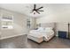 Bedroom with ceiling fan, bedside table with lamp, and hardwood flooring at 1103 Silo Dr, St Cloud, FL 34771