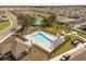 A resort-style community pool featuring lounge chairs, shady trees, and landscaped grounds at 1103 Silo Dr, St Cloud, FL 34771
