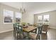 Cozy dining area with table, chairs, bench and a clear view into the home's living area at 1103 Silo Dr, St Cloud, FL 34771