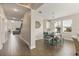 Hallway view into a dining area with wood-look floors, and a connecting Gathering room beyond at 1103 Silo Dr, St Cloud, FL 34771