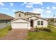 Charming home with well-maintained lawn, brick driveway, and inviting front entrance at 1103 Silo Dr, St Cloud, FL 34771