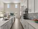 Bright, open kitchen with white cabinets, island, and stainless steel appliances at 1103 Silo Dr, St Cloud, FL 34771