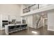 Kitchen with black bar stools and island adjacent to staircase and second story landing at 1103 Silo Dr, St Cloud, FL 34771