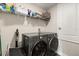 The laundry room features modern washer and dryer machines with storage space at 1103 Silo Dr, St Cloud, FL 34771