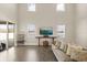 Bright living room with soaring ceilings, large windows, stylish furniture and hardwood floors at 1103 Silo Dr, St Cloud, FL 34771