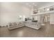 Open-concept living room with a large sectional sofa, hardwood floors and view of upstairs at 1103 Silo Dr, St Cloud, FL 34771