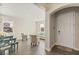 Open-concept living area with front door and view into sitting area and dining space at 1103 Silo Dr, St Cloud, FL 34771