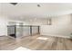 Well-lit loft space with railings overlooking the floor below and beautiful wood-look floors at 1103 Silo Dr, St Cloud, FL 34771