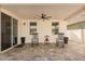 Covered patio with fan, comfortable rocking chairs, and beautiful decorative stone pavers at 1103 Silo Dr, St Cloud, FL 34771
