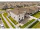 Aerial view of the home's rear exterior, fenced yard, and stone patio, set in a well-maintained community at 1103 Silo Dr, St Cloud, FL 34771