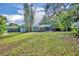 A view of the home's backyard featuring a screened-in patio at 1111 Lynx Trl, Winter Springs, FL 32708
