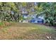 This backyard includes an inground swimming pool and lots of trees at 1111 Lynx Trl, Winter Springs, FL 32708