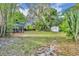 Backyard featuring a storage shed and screened gazebo with lush greenery and mature trees at 1111 Lynx Trl, Winter Springs, FL 32708