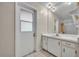 Bright bathroom featuring white vanity, tile floors, and shower with white-framed glass door at 1111 Lynx Trl, Winter Springs, FL 32708
