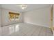 Neutral bedroom with tile floors, window to the front yard, and closet at 1111 Lynx Trl, Winter Springs, FL 32708