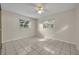 Bedroom featuring tile floors, two windows with natural light, and a ceiling fan with great ventilation at 1111 Lynx Trl, Winter Springs, FL 32708
