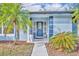 Stylish blue front door with decorative glass and sidelights, enhanced by lush plantings at 1111 Lynx Trl, Winter Springs, FL 32708