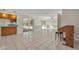 Bright living room with tile flooring, neutral tones, and large sliding doors to the screened lanai at 1111 Lynx Trl, Winter Springs, FL 32708
