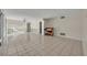 Large living room with neutral paint, decorative wainscoting, tile floors, and views of the backyard at 1111 Lynx Trl, Winter Springs, FL 32708