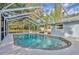 Pool featuring a brick border and screen enclosure with a view of the sky and surrounding trees at 1111 Lynx Trl, Winter Springs, FL 32708
