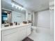 Bright bathroom with a modern vanity, updated lighting, and a shower-tub combination with patterned shower curtain at 1150 Carmel Cir # 301, Casselberry, FL 32707