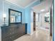 Bedroom with ensuite bathroom, dresser, closet, and light blue walls with white trim at 1150 Carmel Cir # 301, Casselberry, FL 32707