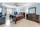 Cozy bedroom with soft blue walls, dark furniture, and a comfortable bed with stylish accents at 1150 Carmel Cir # 301, Casselberry, FL 32707