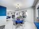 Open-concept dining area with a round table, stylish chairs, and a view of the kitchen and living area at 1150 Carmel Cir # 301, Casselberry, FL 32707