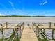 Wooden dock extending into a serene lake with a clear blue sky at 1150 Carmel Cir # 301, Casselberry, FL 32707