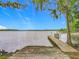 Wooden dock overlooking a peaceful lake with trees and sky at 1150 Carmel Cir # 301, Casselberry, FL 32707