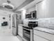Modern kitchen design with stainless steel refrigerator, range, microwave, and beautiful granite countertops at 1150 Carmel Cir # 301, Casselberry, FL 32707